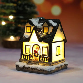 Casette di Natale in miniatura decorate con luci LED.
